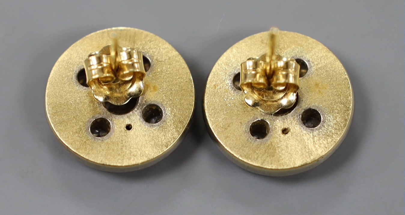 A modern pair of textured yellow metal and diamond cluster set disc earrings, with white metal border, diameter 16mm, gross weight 11.2 grams.